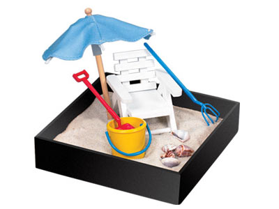 sandbox with lounge chair umbrella pail and shovel and sea shells