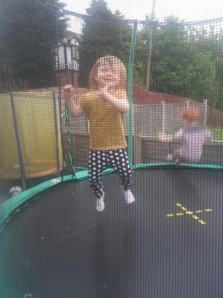 Young girl jumping on trampoline
