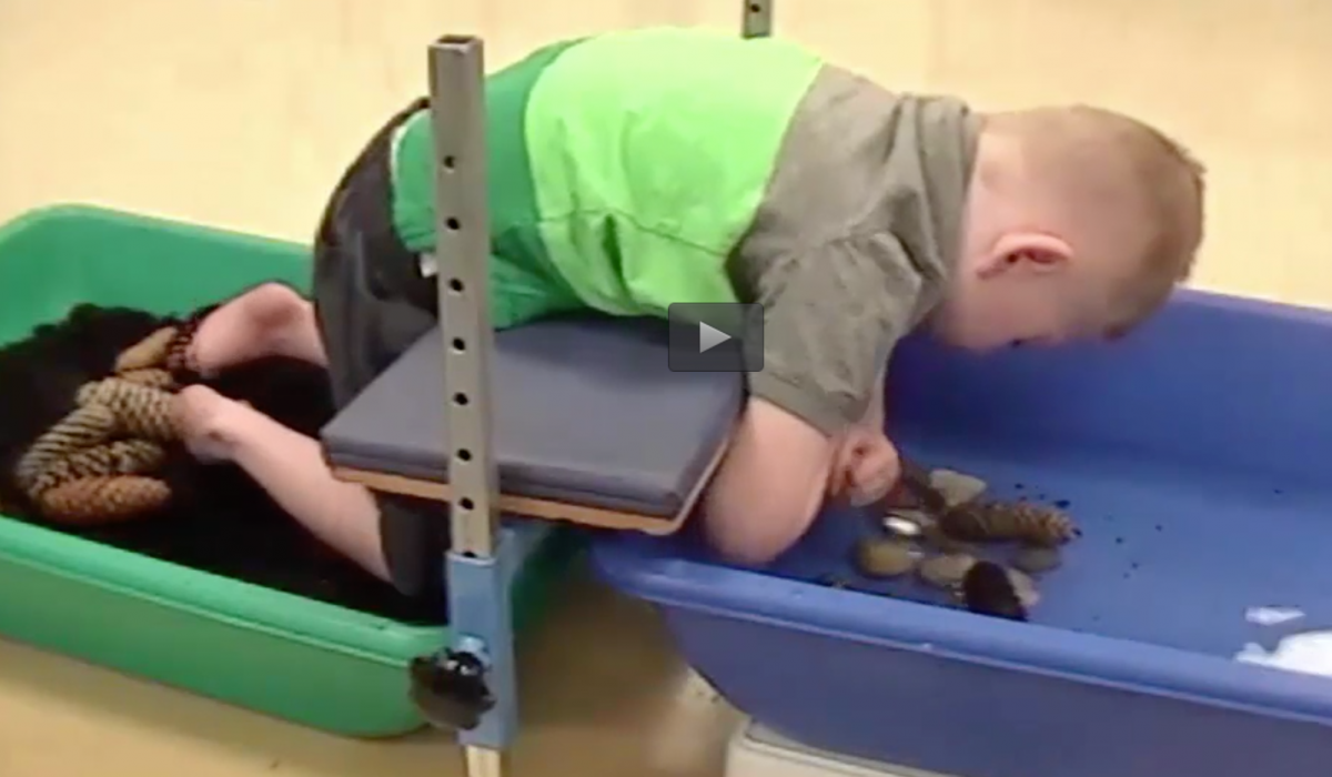 A boy participates in a science lesson using a support bench. A boy participates in a science lesson using a support bench.