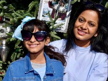 Girl with sunglasses standing with her mother