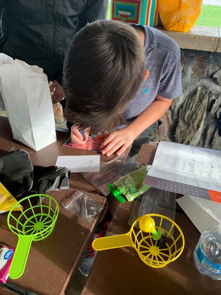 A boy practices using a slate.