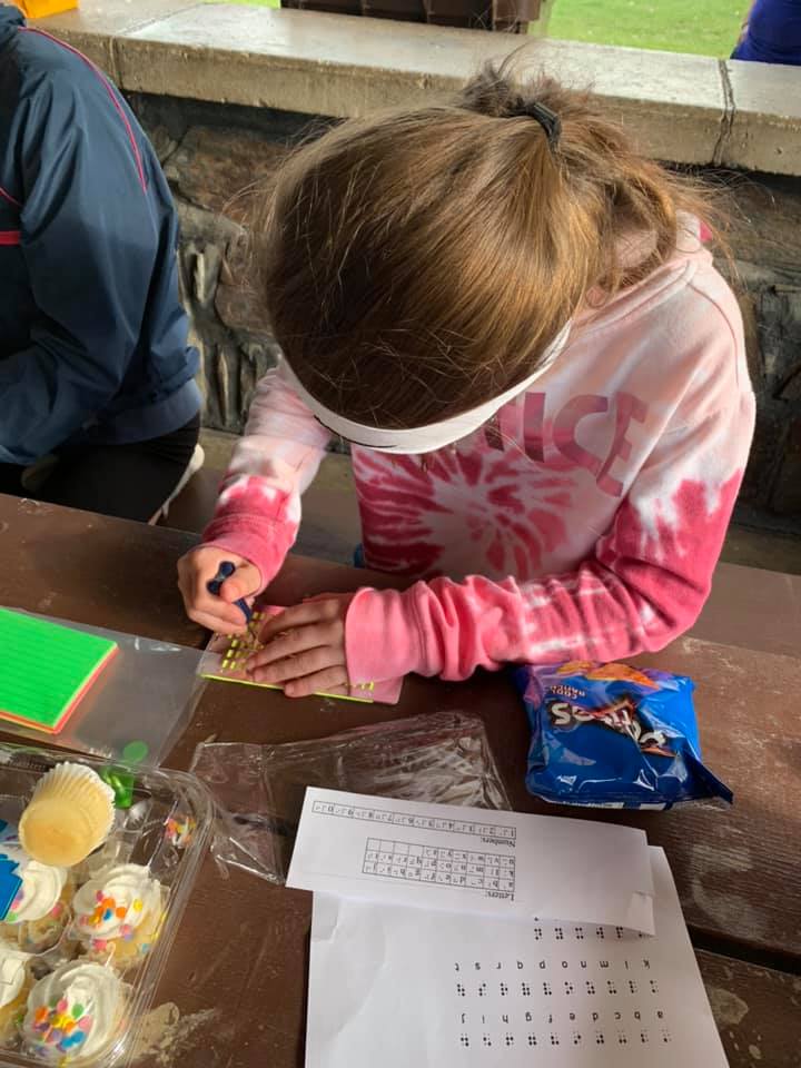 A girl practices using a slate.