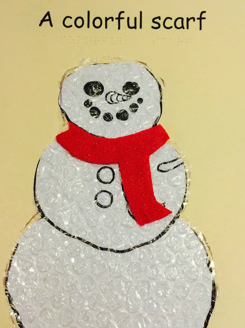 a colorful scarf on the snowman