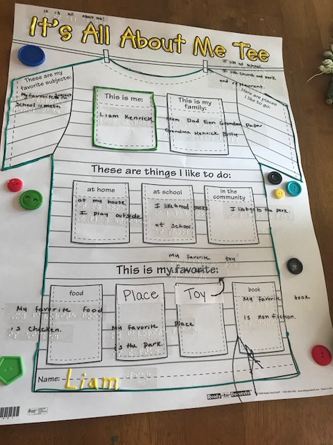 Click to enlarge finished poster with puff paint, braille labels, and button decorations. Finished poster with puff paint, braille labels, and button decorations