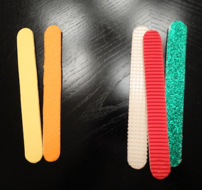 tongue depressors covered in textured multicolored paper