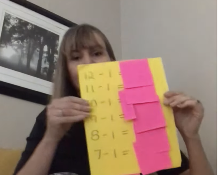 Removable sticky notes covering answer on a math worksheet