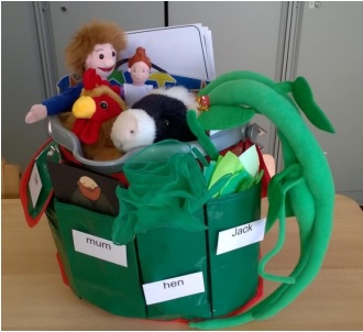 a bucket with items relating to Jack and the Beanstalk including a doll, a plush dragon, and other items