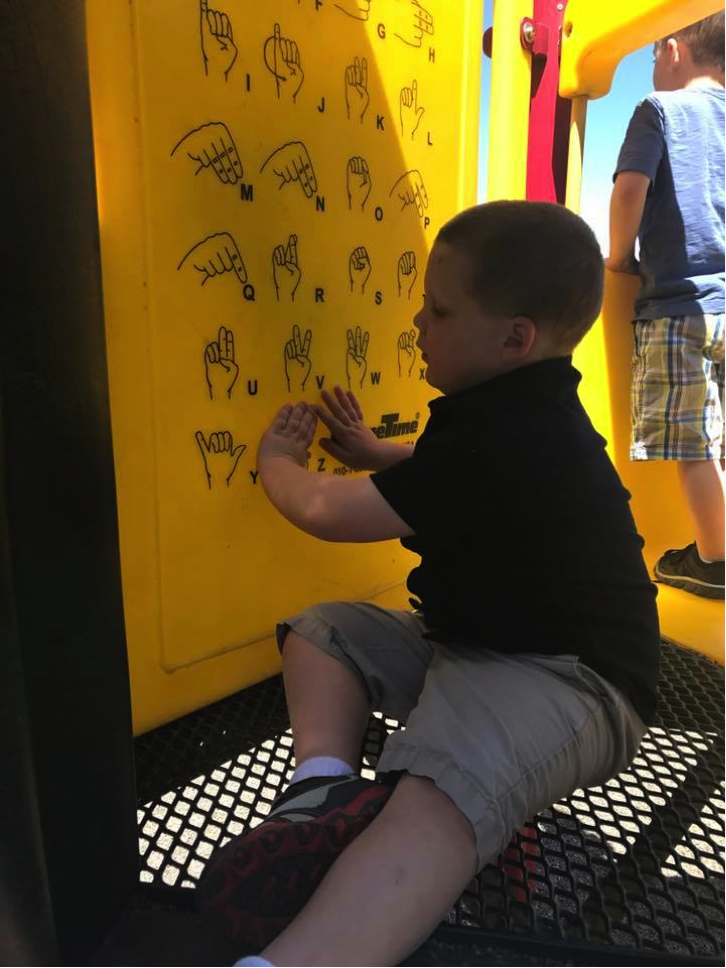 Reading braille at a park.