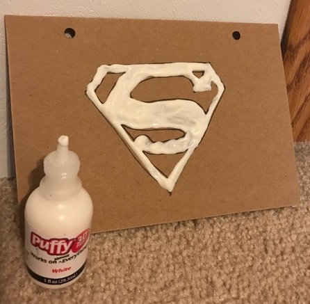 the Superman logo in puffy paint