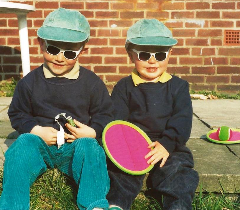 two children wearing hats and sunglasses