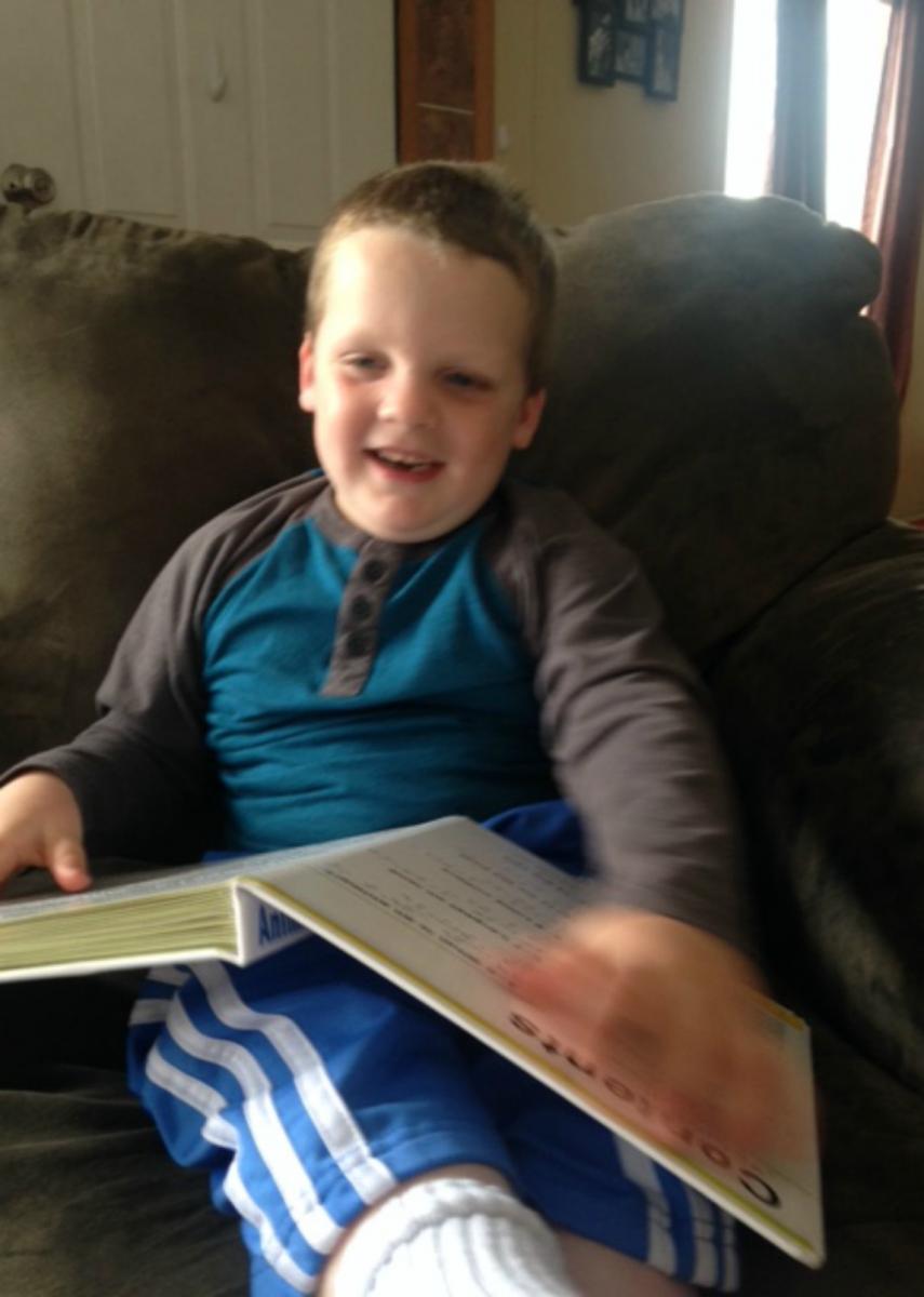 A young boy reads the table of contents.