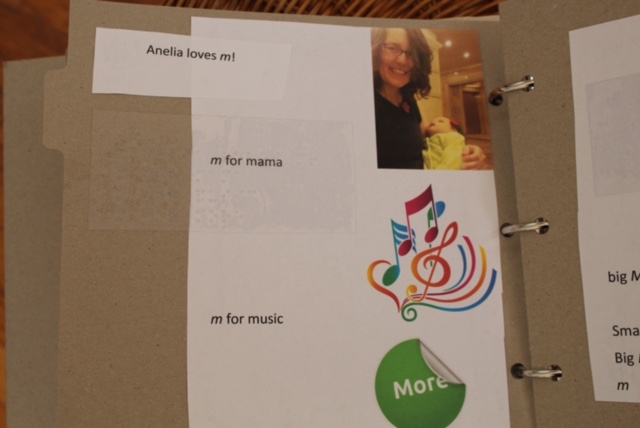 a page of a tactile book showing items that begin with m, like mama, music, and more