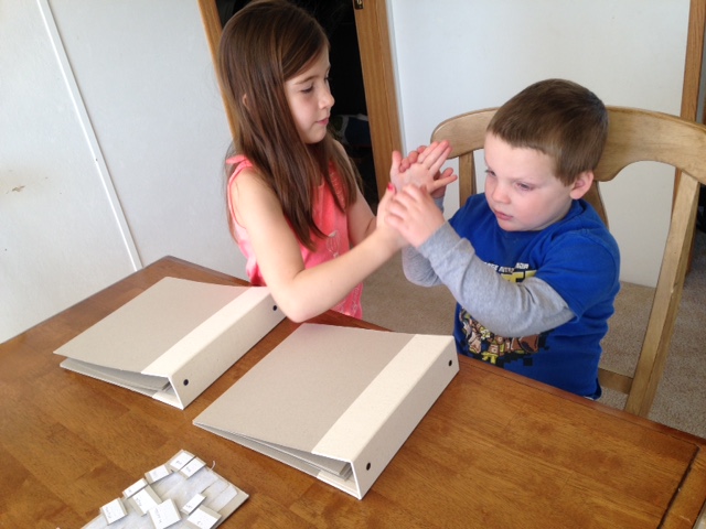 Reading the book together using tactile sign Reading book together using tactile sign