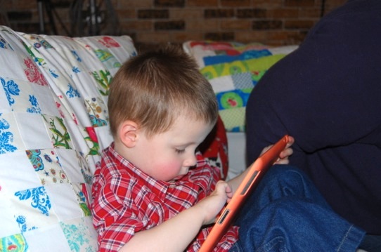 young boy using ipad