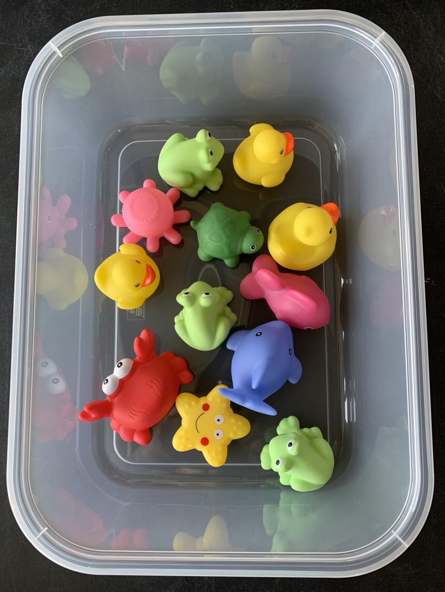Water Task Box with small plastic frogs, ducks, fish, and crabs in a clear plastic bin Water Task Box with small plastic frogs, ducks, fish, and crabs in a clear plastic bin