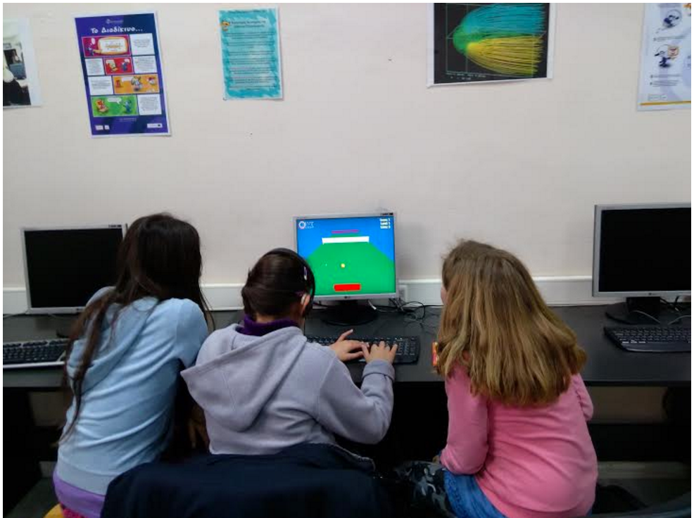 Students playing tennis game on computer