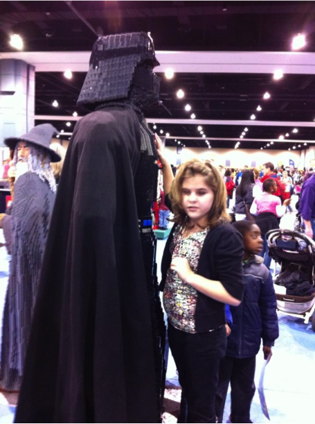 Girl touching a person in Darth Vader costume