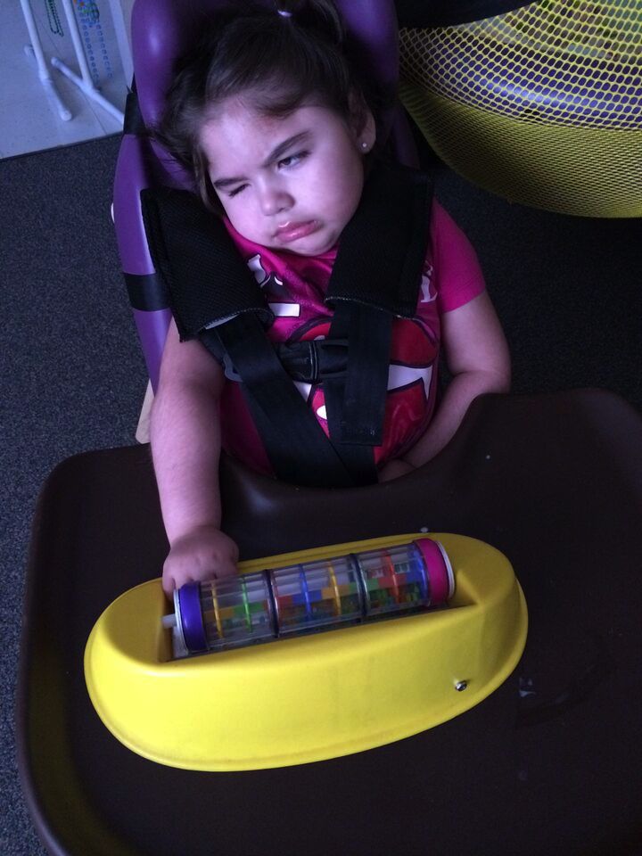 Click to enlarge child with toy. student playing with toy