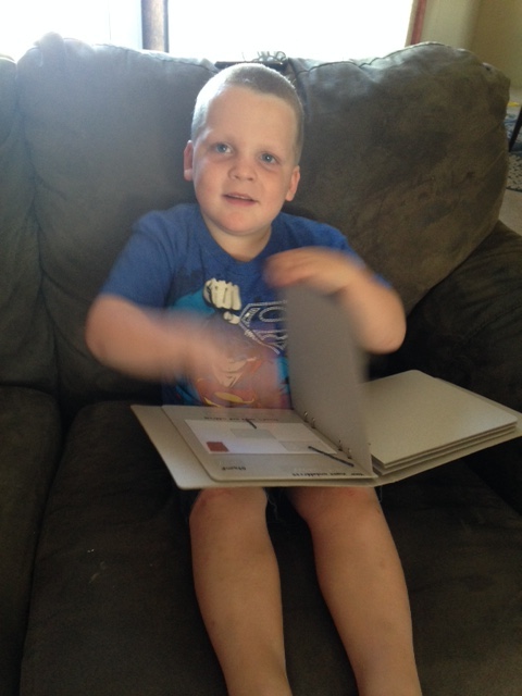 Young boy turning pages of mail book