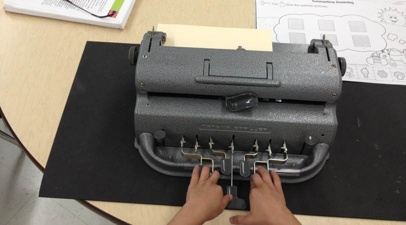 Fingers on a braillewriter