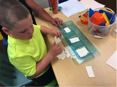 Boy sorting braille cards
