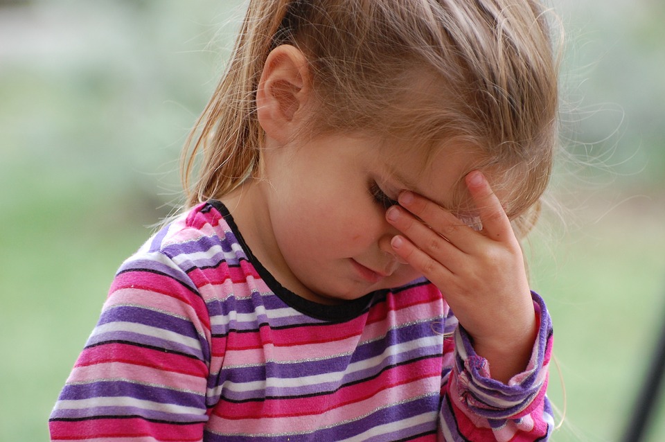 girl holding his face in his hands