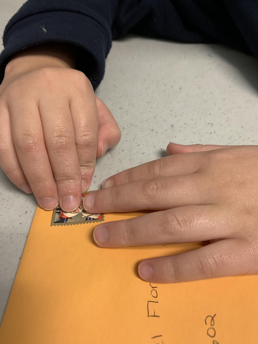 Placing the stamp on the envelope Placing the stamp on the envelope