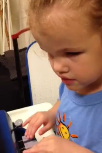 A young girl uses a braille writer