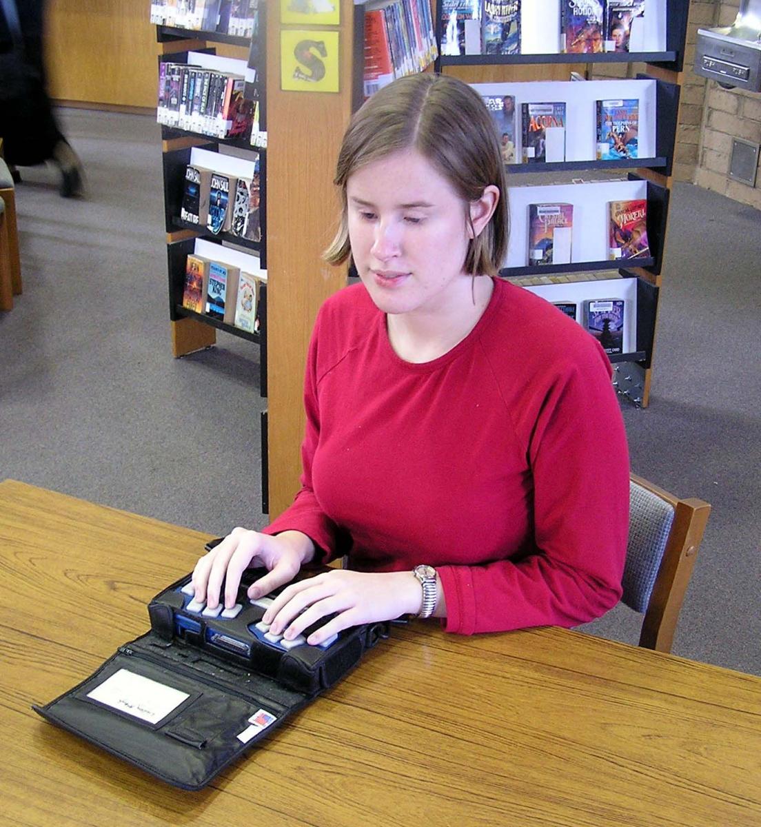 High school student using the Pac Mate in a school library.