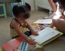 Toddler exploring braille  book