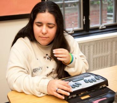 Photo of girl using a braille notetaker.