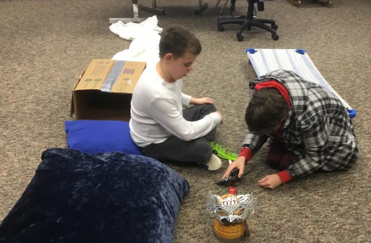 Two students collaborate to co-create a play-based story.