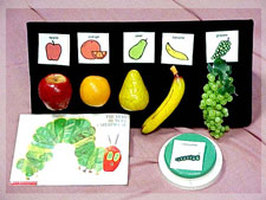 Story board for Velcro board with plastic fruit and picture symbols of fruit.