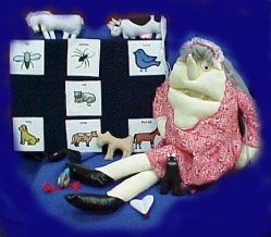 Puppet of old lady with picture cards and objects of animals.