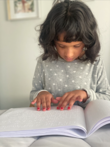 Ankitha reading a braille book