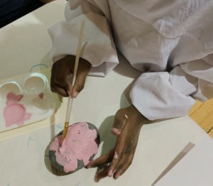 Student painting a rock.