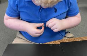 Young student beading.