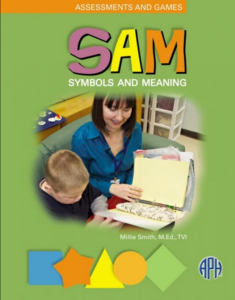 Cover of SAM symbols and meaning guide book available through APH with a photo in the middle of a teacher and her student exploring materials in a 3-ring binder