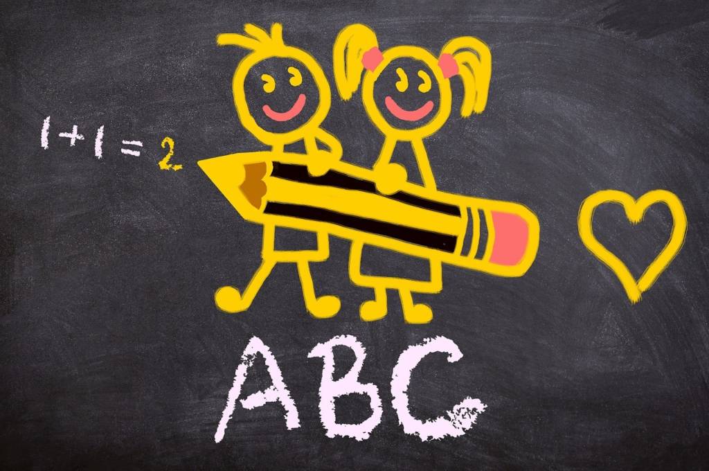 Chalkboard drawing of a boy and girl holding a giant pencil with ABC, a math problem, and a heart around them.