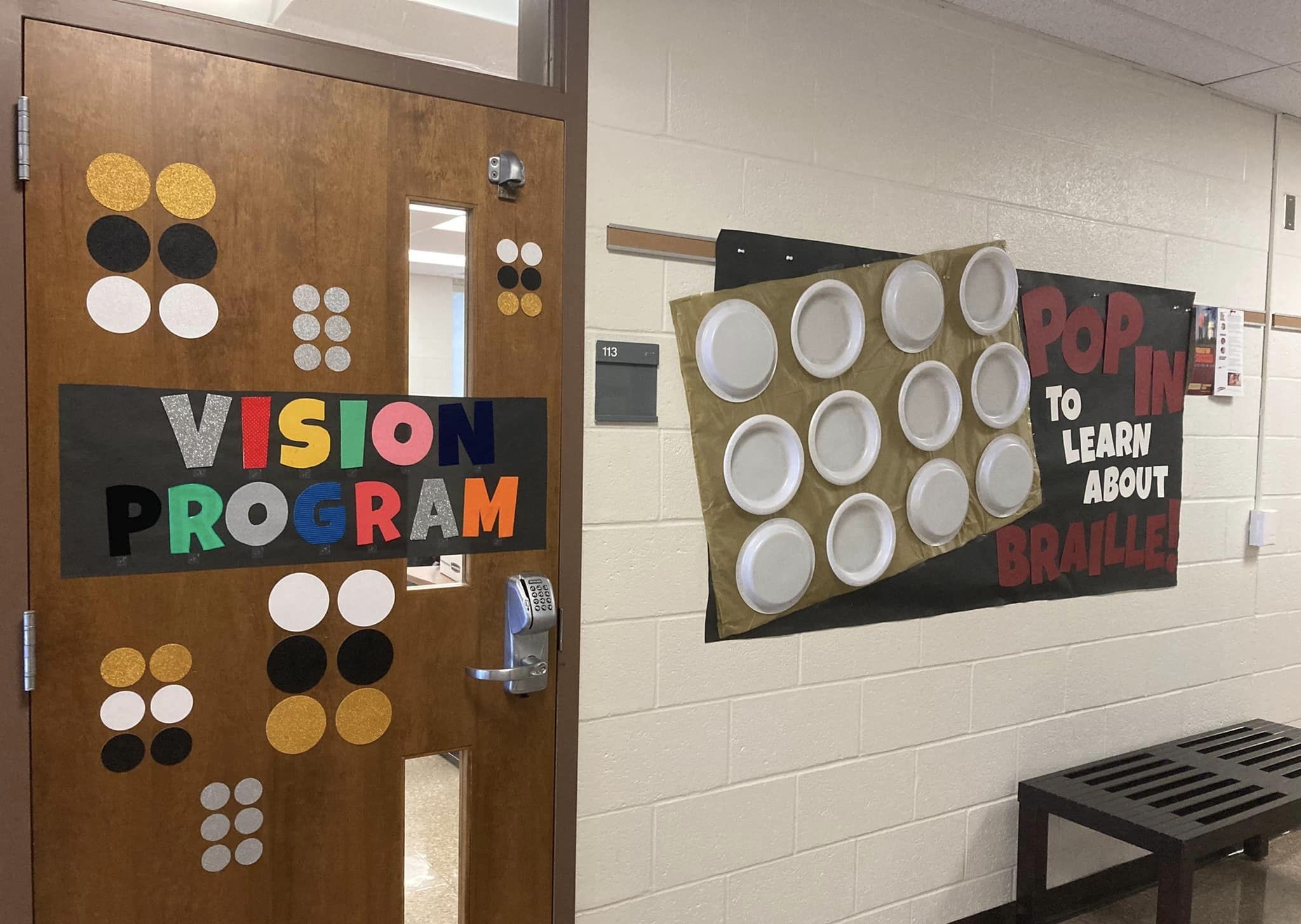Door and wall display for a vision classroom that has textured letters and braille letters.