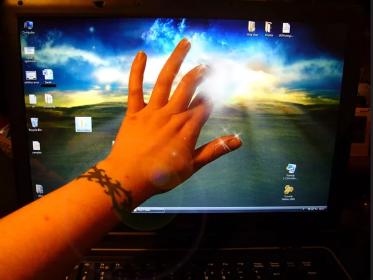Handing touching a computer screen.