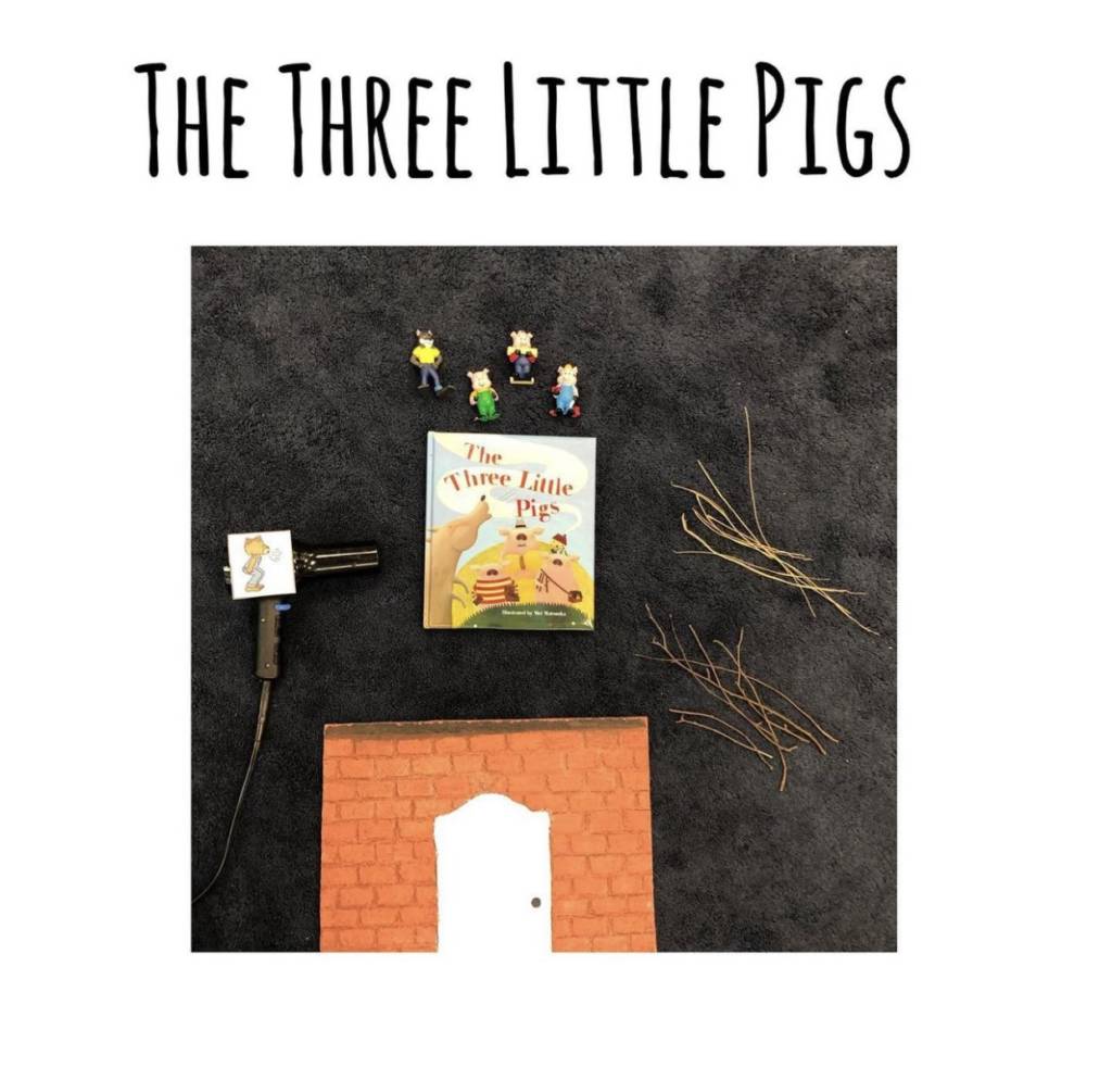 Book, The Three Little Pigs with a hairdryer as the wolf and materials to blown down.
