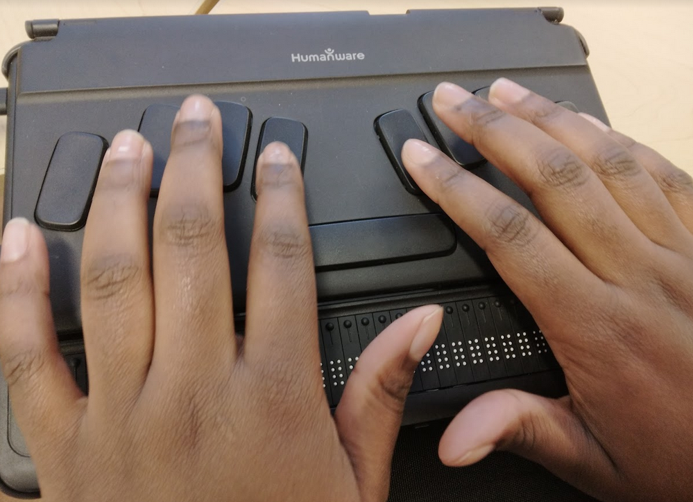 Hands on a refreshable braille device by Humanware.