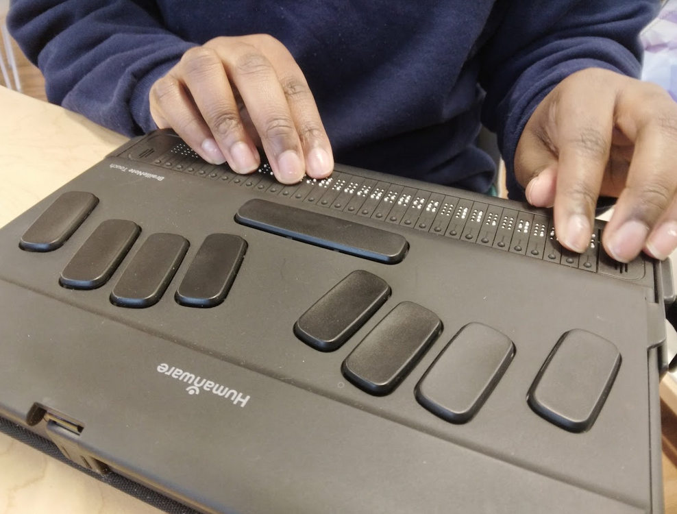 Hands on a refreshable braille device
