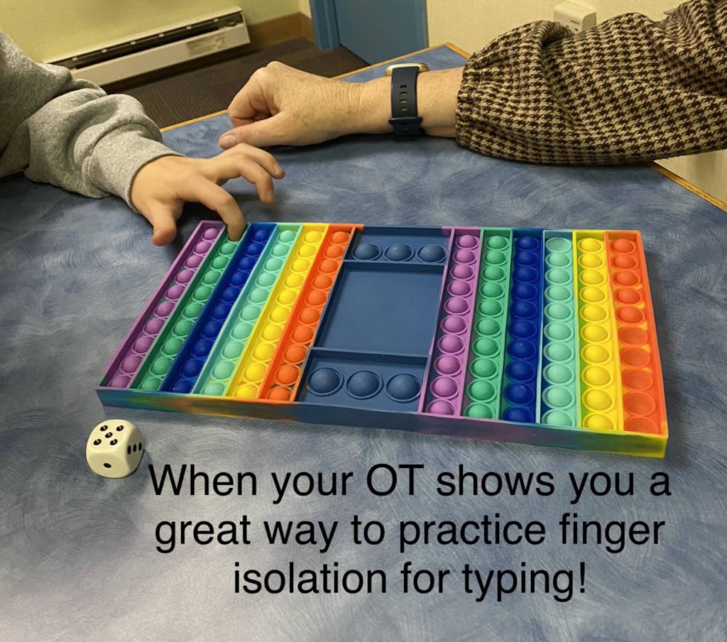 Bumpy Dots Game and the student is rolling a dice and using different fingers to put the bubble dot in to practice finger isolation. 