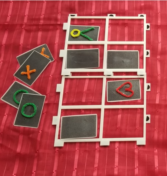 Memory card game with raised line shapes.