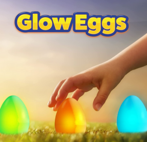 Glow eggs with a picture of a child's had reaching for one of three eggs on the grass.
