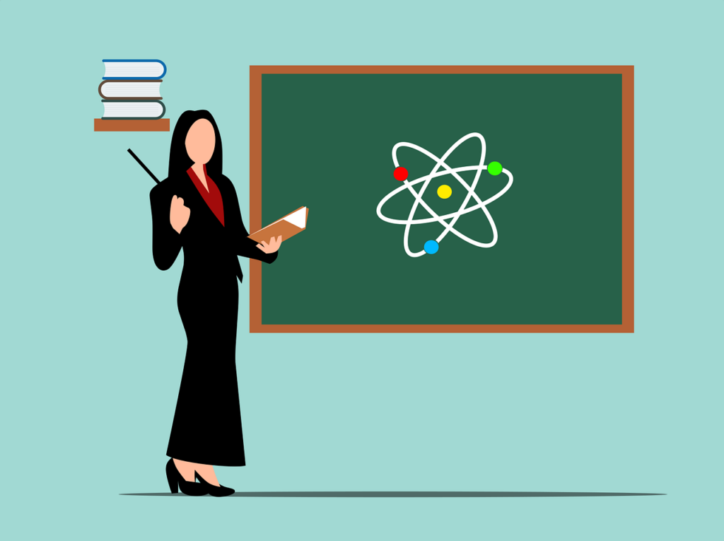 Woman lecturing with a book and pointer in her hand and a black board behind her.