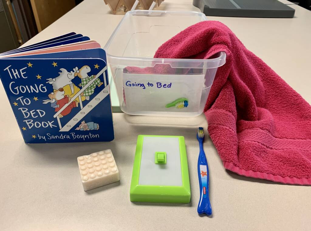 Going To Bed book box with a light switch, tooth brush, towel, and soap