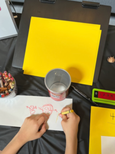 Work station that includes a black table top, slant board, large number line, paper and crayons.